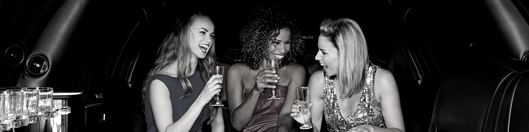 girls having drinks in a limo 